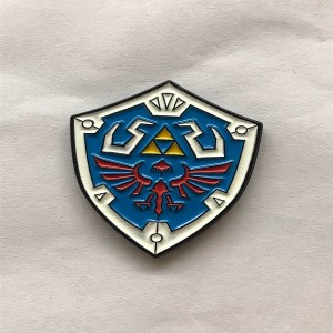 iconic Hylian Shield design soft enamel pins with glow